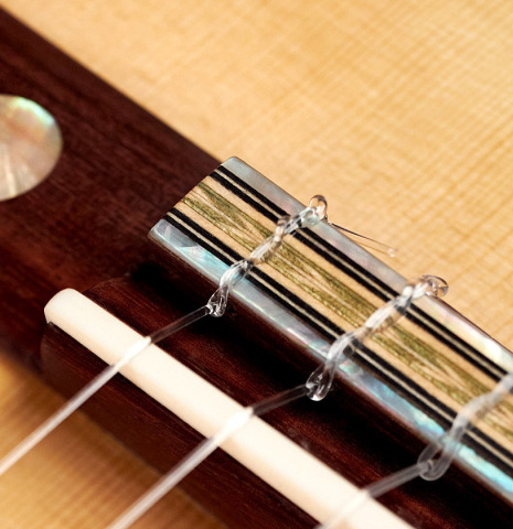 The bridge and tie block of a 2022 Dominik Wurth "Torres" classical guitar with Tornavoz SP/IN