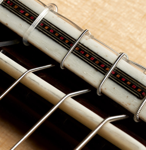 The bridge, tie-block and saddle of a 2024 Gao Yi classical guitar made of spruce and CSA rosewood