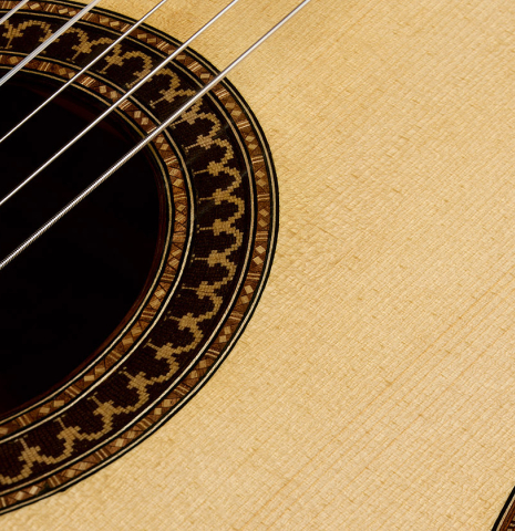 The soundboard and rosette of a 2026 Fructuoso Zalapa "Romanillos" classical guitar made of spruce and Kingwood