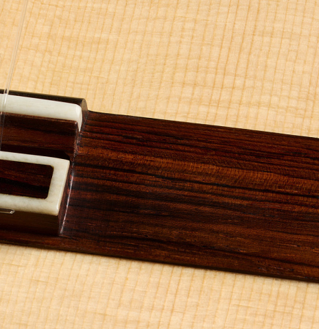 The bridge, tie-block and saddle of a 2025 Antonio Zwirn classical guitar made of spruce and cocobolo
