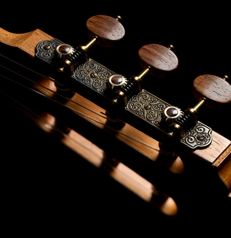 The headstock and tuning machines of a 2025 Colin van Aelbrouck "Negra" flamenco guitar made of cedar and Indian rosewood