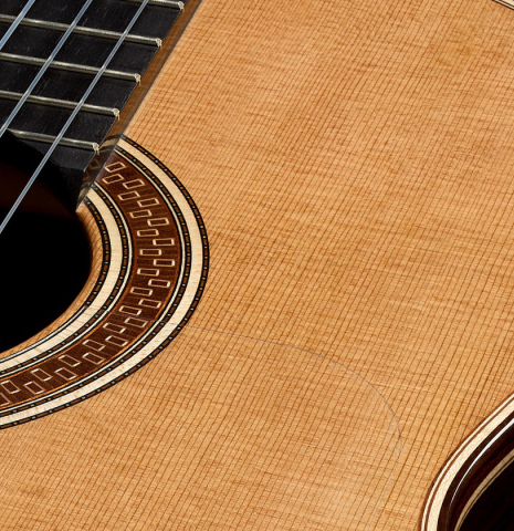 The soundboard and rosette of a 2025 Colin van Aelbrouck "Negra" flamenco guitar made of cedar and Indian rosewood