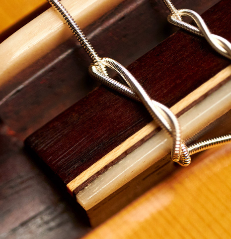 The bridge of a 2012 Marlon Navarro Alvarez Student Flamenco guitar made of spruce and cypress