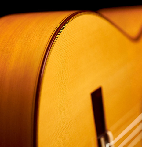 The binding and side of a 2012 Marlon Navarro Alvarez Student Flamenco guitar made of spruce and cypress