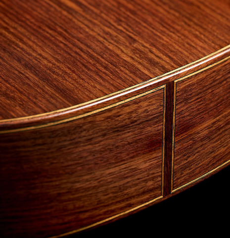 The back and sides at the foot of a 2025 Manuel Arango "Negra" flamenco guitar made of spruce and Indian rosewood