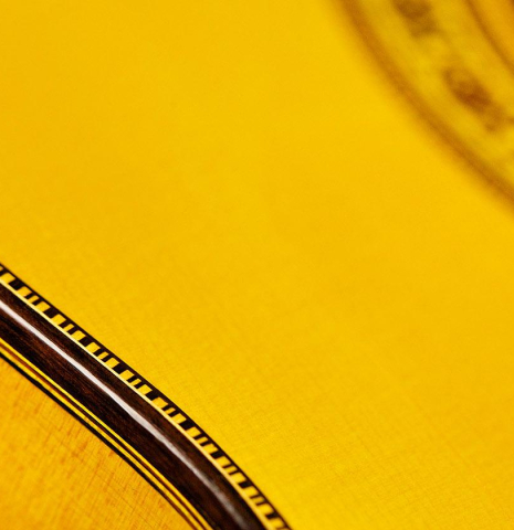The binding and purfling of a 2015 Francisco Barba flamenco guitar made with spruce and cypress
