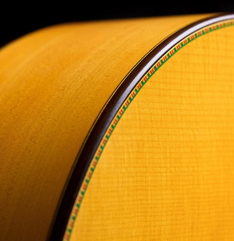 The top, side, binding and purfling of a 2007 Francisco Barba flamenco guitar made of spruce and cypress