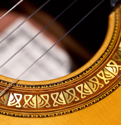 The ornate rosette of a 2016 Francisco Barba CD/MH Flamenco guitar made with cedar top and mahogany back and sides