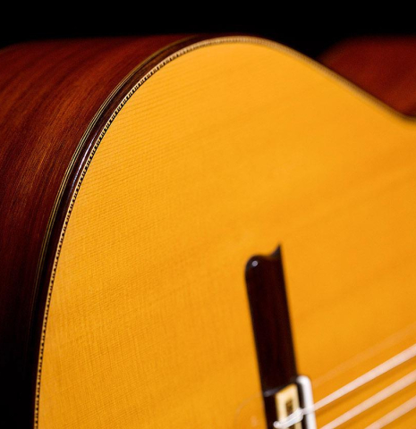 The sides, purflngs, bindings and top of a 2016 Francisco Barba CD/MH Flamenco guitar made with cedar top and mahogany back and sides