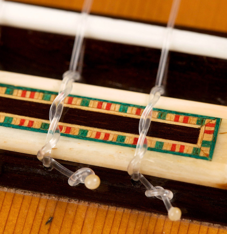 The tie block of a 2007 Francisco Barba flamenco guitar made with cedar and cypress
