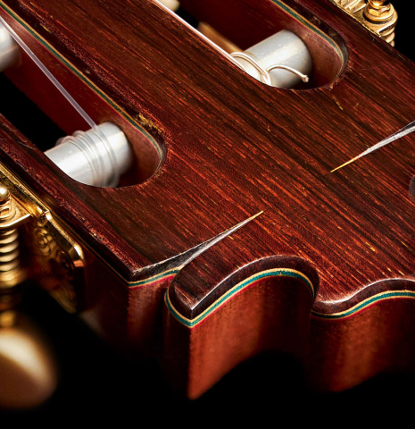 The headstock of a 2015 Francisco Barba flamenco blanca guitar made of spruce and cypress.