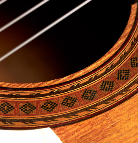 A close-up of the rosette of a 1950 Marcelo Barbero flamenco guitar with traditional pegs made of spruce and cypress