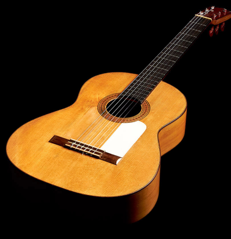 The front and tap plate of a 1950 Marcelo Barbero flamenco guitar with traditional pegs made of spruce and cypress