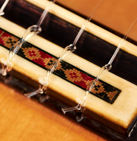 The bridge, saddle and nylon strings of a 1962 Marcelo Barbero (Hijo) flamenco guitar made of spruce and cypress