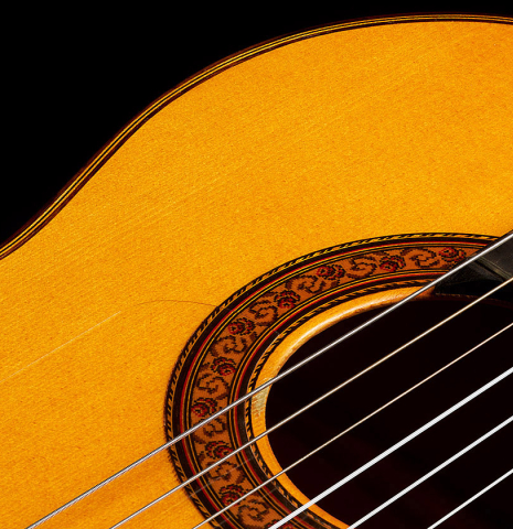 The soundboard and rosette of a 2002 Jose Lopez Bellido 1aF flamenco guitar made of spruce and cypress