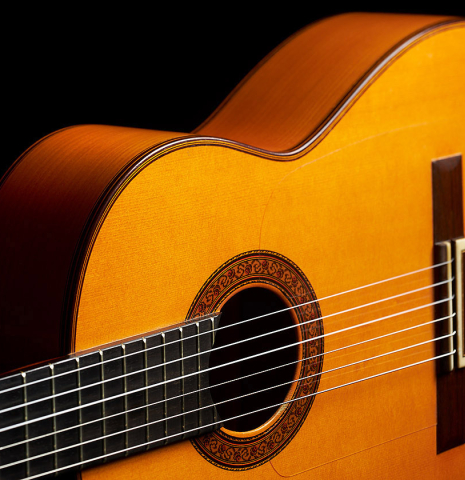 The top and sides of a 2002 Jose Lopez Bellido 1aF flamenco guitar made of spruce and cypress