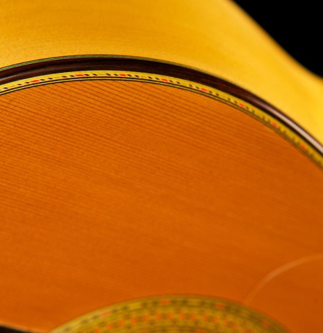 The side and purfling of a 2004 Paulino Bernabe "Blanca" flamenco guitar made of cedar and cypress