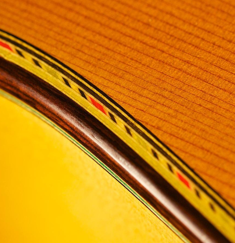 The purfling and binding of a 2004 Paulino Bernabe "Blanca" flamenco guitar made of cedar and cypress