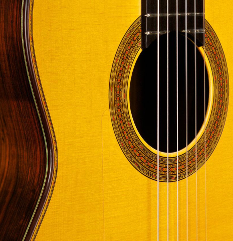 The top and rosette of a 2004 Paulino Bernabe "Flamenco Negra" flamenco guitar made of spruce and CSA rosewood
