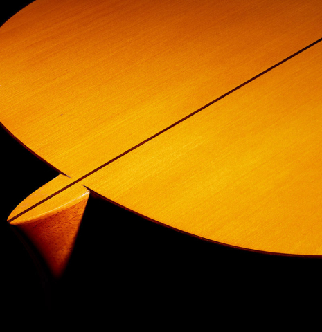 The heel, back binding and purflings of a 1978 Paulino Bernabe "Blanca" flamenco guitar made of cedar and cypress with traditional wooden tuning pegs