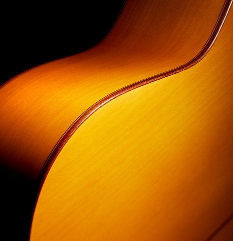 The back, side, binding and purflings of a 1978 Paulino Bernabe "Blanca" flamenco guitar made of cedar and cypress with traditional wooden tuning pegs