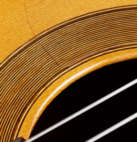 Closeup detail of the rosette of a 1978 Paulino Bernabe "Blanca" flamenco guitar made of cedar and cypress with traditional wooden tuning pegs
