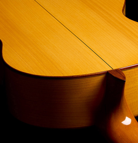 The heel, back binding and purfling of a 2012 Ron Bushman w/pegs flamenco guitar made of spruce and cypress