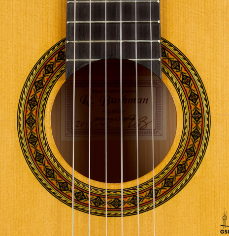 The rosette of a 2012 Ron Bushman w/pegs flamenco guitar made of spruce and cypress