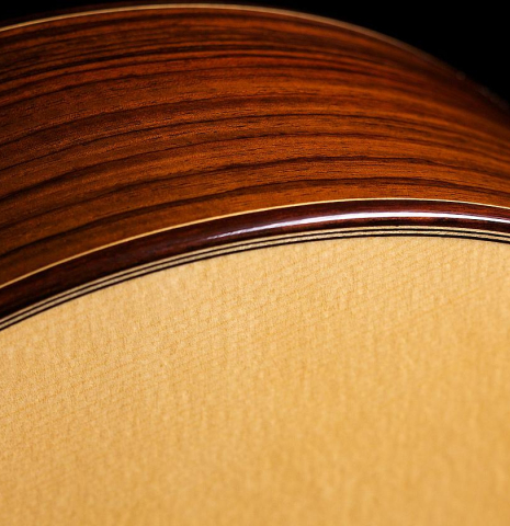 The soundboard and side of a 2022 Hermanos Camps &quot;Primera Negra&quot; flamenco guitar made of spruce and Indian rosewood