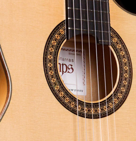 The soundboard and cutaway of a Hermanos Camps &quot;FL11C Blanca&quot; flamenco guitar made of spruce and cypress