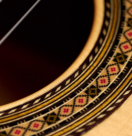 The close-up of the rosette of a 2022 Vicente Carrillo &quot;1aF Blanca&quot; flamenco guitar made with spruce top and cypress back and sides