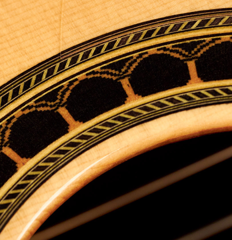 The rosette of a 2004 Vicente Carrillo &quot;1aF Negra&quot; flamenco guitar made of spruce and padauk