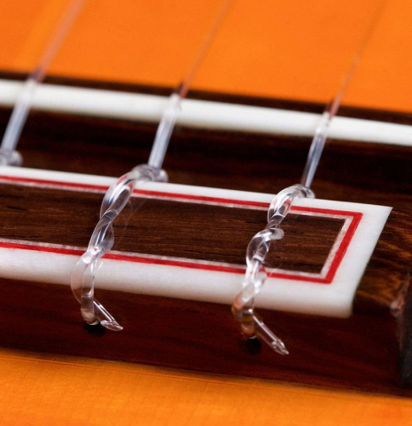 The bridge and saddle of a 2018 Felipe Conde &quot;Pepe Habichuela&quot; flamenco guitar made of spruce and cypress