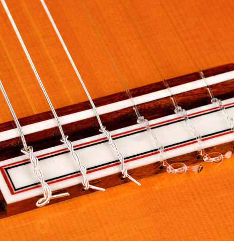 The bridge and saddle of a 2019 Felipe Conde "Reedicion 1975" flamenco guitar made with spruce top and pau ferro back and sides 