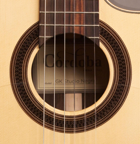 The rosette of a Cordoba &quot;GK Studio Negra&quot; electric/acoustic guitar made of spruce and Indian rosewood