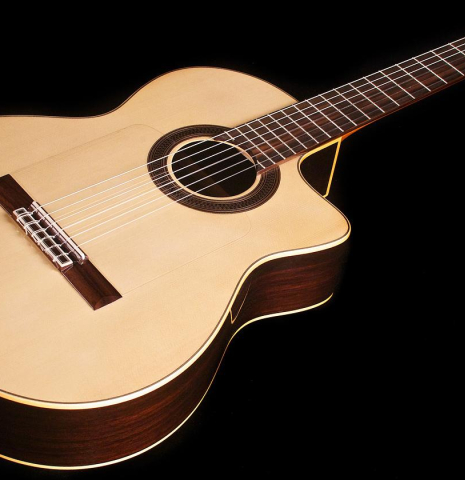 The cutaway soundboard of a Cordoba &quot;GK Studio Negra&quot; electric/acoustic guitar made of spruce and Indian rosewood