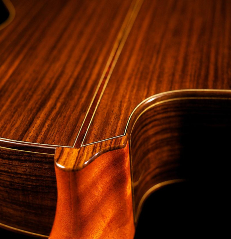 The back, sides and cutaway of Cordoba "GK Pro Negra" classical guitar made with spruce and Indian rosewood and with electronics