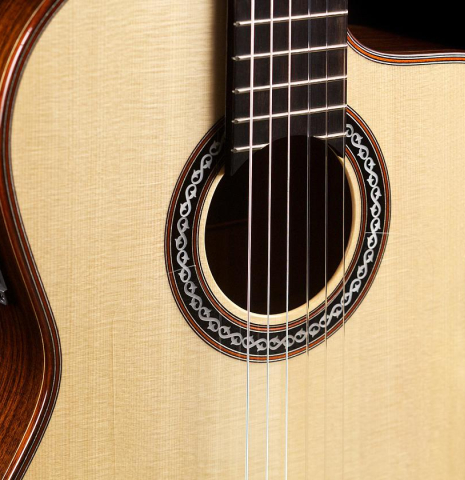 The front and cutaway of Cordoba "GK Pro Negra" classical guitar made with spruce and Indian rosewood and with electronics