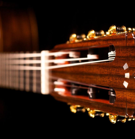 The headstock of Cordoba "GK Pro Negra" classical guitar made with spruce and Indian rosewood and with electronics