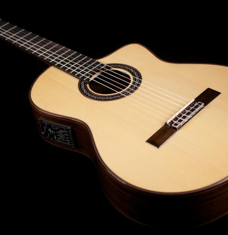 The cutaway body of Cordoba "GK Pro Negra" classical guitar made with spruce and Indian rosewood and with electronics