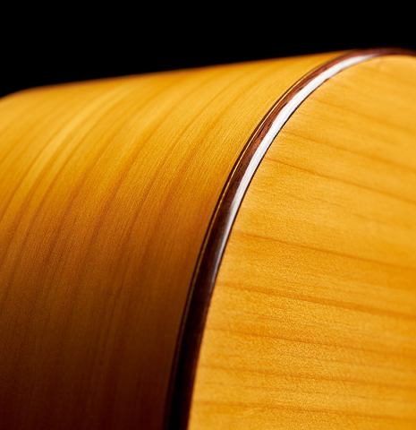 The sides and back binding of a 2018 Luis Fernandez de Cordoba "Blanca" flamenco guitar made of spruce and cypress