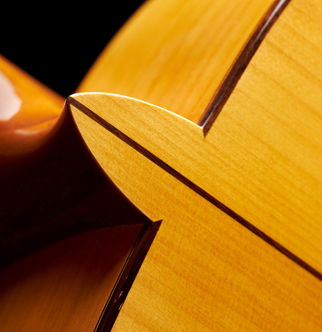 The heel and back center seam of a 2018 Luis Fernandez de Cordoba "Blanca" flamenco guitar made of spruce and cypress
