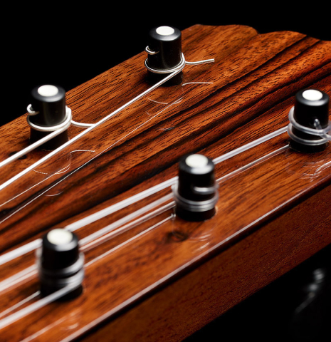 The headstock and tuning pegs of a 2024 Andy Culpepper w/pegs flamenco guitar made of cedar and cypress