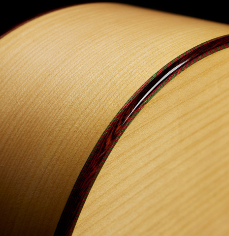 The back, side, binding and purflings of a 2024 Andy Culpepper w/pegs flamenco guitar made of cedar and cypress
