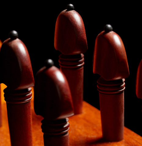 The traditional wooden tuning pegs of a 1957 Manuel de la Chica flamenco guitar with pegs made of spruce and cypress
