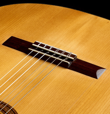The soundboard and bridge of a 1961 Manuel de la Chica flamenco blanca guitar made of spruce and cypress