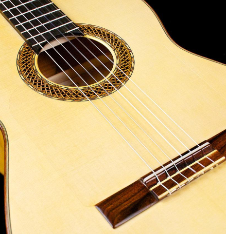 The soundboard of a 2017 Ethan Deutsch flamenco guitar with pegs made with spruce and cypress