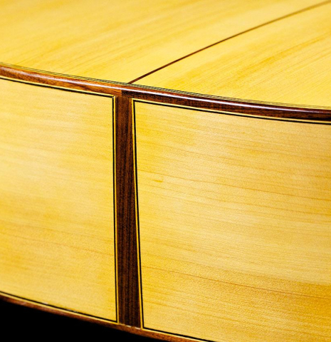 The back and sides at the foot of a 2017 Ethan Deutsch flamenco guitar with pegs made with spruce and cypress