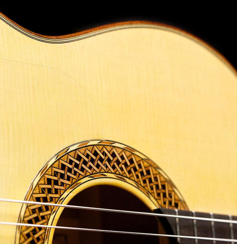 The soundboard and rosette of a 2017 Ethan Deutsch flamenco guitar with pegs made with spruce and cypress