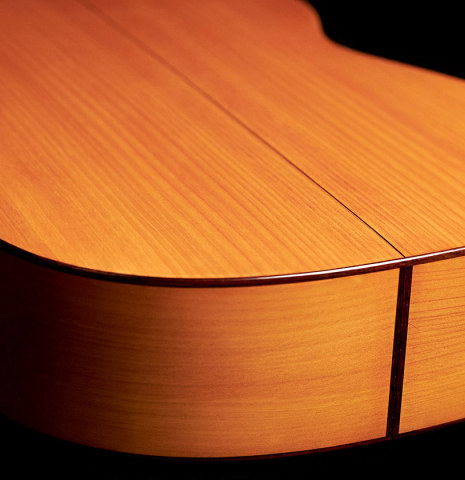 The lower bout of a 1985 Lester DeVoe flamenco guitar made with spruce and cypress.